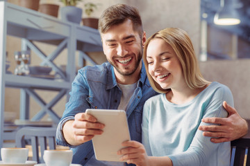 Cheerful couple sitting at the table 