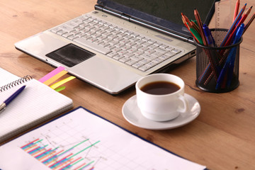 Office table with blank notepad and laptop 