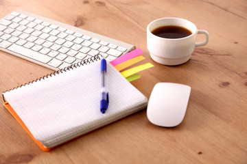 Office table with blank notepad and laptop 