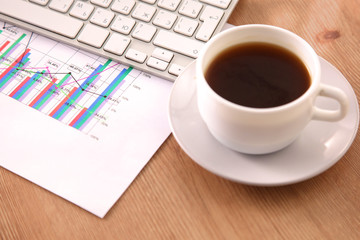 Office table with blank notepad and laptop 