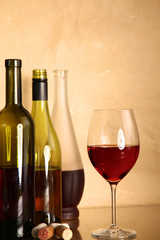 wine bottle and wine glass on a glass table