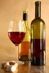 wine bottle and wine glass on a glass table