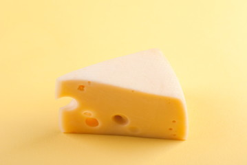 piece of cheese with holes on isolated background