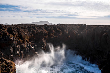 Huge ocean splash on the rocky Los Hervideros coast on Lanzarote island in Spain
