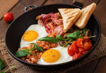 Fotobehang Spiegeleieren English breakfast - fried egg, beans, tomatoes, mushrooms, bacon and toast