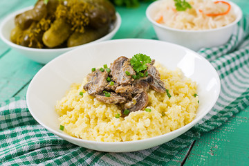Millet porridge with mushrooms in a white bowl