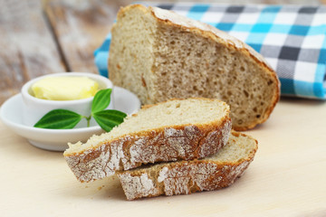 Slices of traditional rustic rye bread on wooden board

