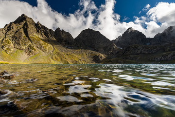 Fototapeta na wymiar Picturesque lake in valley of Caucasus mountains in Georgia