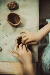 children's hands sculpts clay