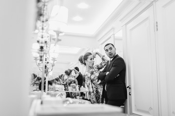 Portrait of a smiling couple posing in interior. they make funny faces