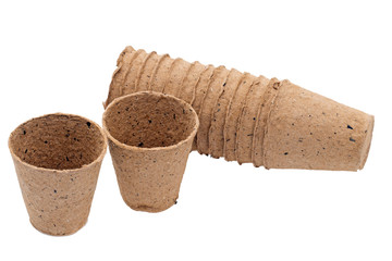 Biodegradable peat seed pots, isolated on white. Spring gardening.
