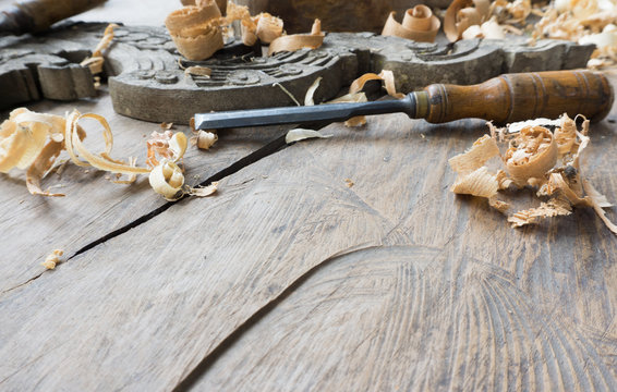 Woodworking tools with wooden background and shavings