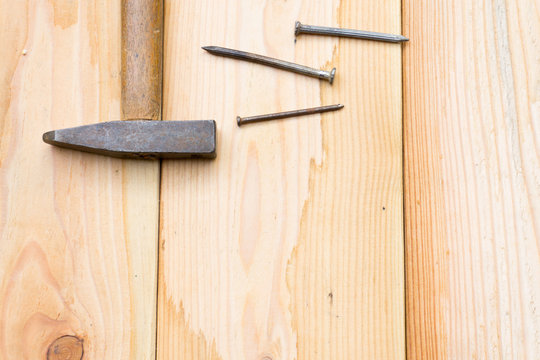 Hammer and nail on wood