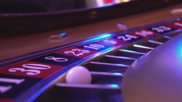 Macro view on a Roulette Wheel in a casino - ball falling in field 30 red 