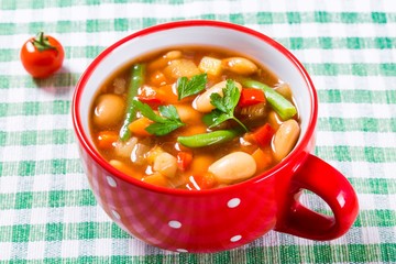 Minestrone vegetable soup with parmesan cheese, beans, cauliflow