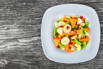 fruit salad in a wide rim square plate, close-up, top-view