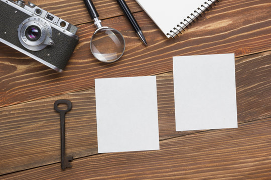 Travel, vacation concept. Camera, notepad, pen, credit card, supplies and photography on office wooden desk table. Top view with copy space for text