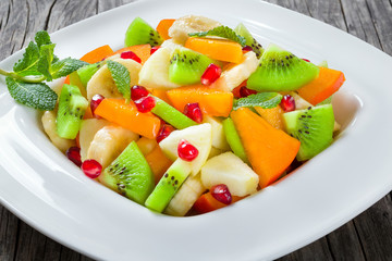 fruit salad in a wide rim square plate, close-up, top-view