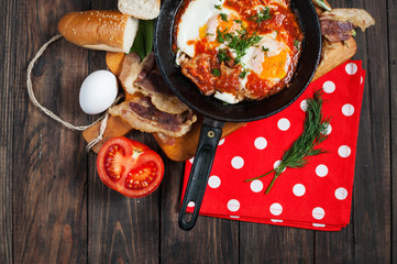 fried eggs with bacon in a pan close-up 