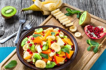 fruit salad in a clay brown dish, close-up, top view