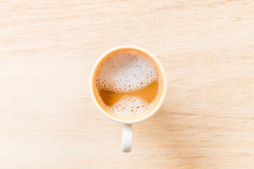 Hot coffee in cup on wooden background