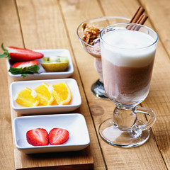 Coffee latte, ice scream and sliced fruits