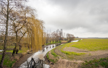 Narrow river meanders diagonally through the countryside