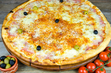 Margarita pizza on a wooden background
