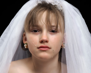 Teen girl - the bride. Portrait of a young, weeping bride. The concept of early marriages with underage children