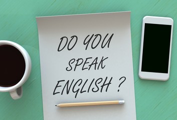 DO YOU SPEAK ENGLISH, message on paper, smart phone and coffee on table