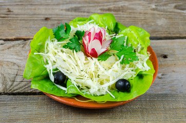 Decorated  cabbage salad on a wooden table