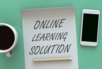 ONLINE LEARNING SOLUTION, message on paper, smart phone and coffee on table