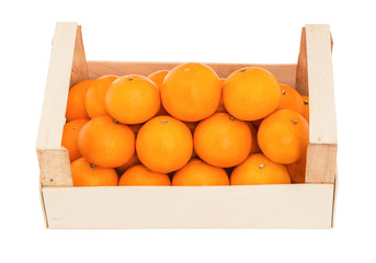 Ripe, juicy tangerines in a wooden box stacked as pyramid. Front view