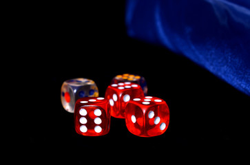 Red and Silver transparent dice on a black felt