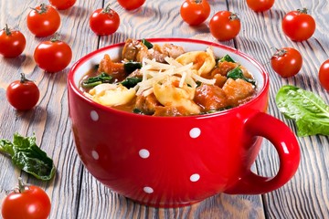 tortellini soup with italian sausages, spinach, tomato, parmesan cheese