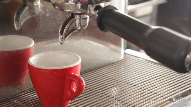 Hot espresso brewing from machine, stock video