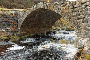 Traditional stone bridge over Old Gang Beck at Old Gang Smelting Mill near Swaledale, Yorkshire Dales National Park.
