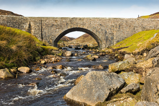 Surrender bridge over Old Gang Beck, Swaledale in the Yorkshire Dales National Park on a warm morning