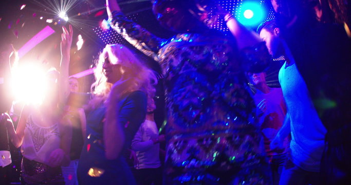 Woman dancing with multicultural girl friends at party in club