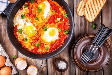 Shakshuka. Fried eggs with tomato, paprika and parsley