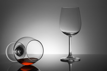 A glass of whiskey and empty glass