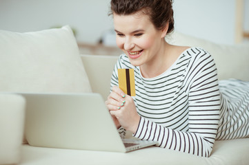 Beautiful girl is buying things though internet