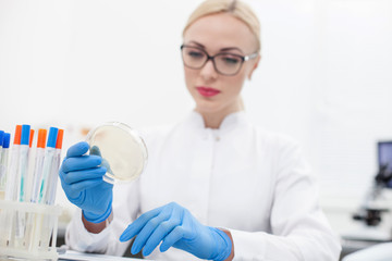 Cheerful young scientist is making an experiment