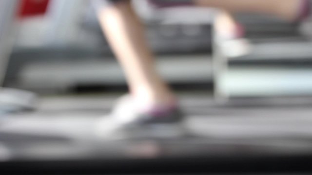 Legs fitness in gym, defocused