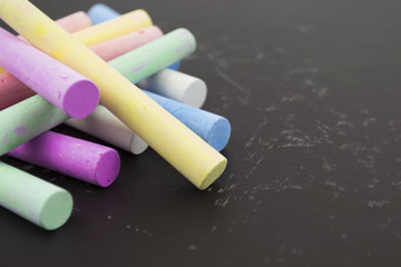 multicolored crayons on a black background
