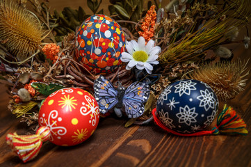 Easter background. colored Easter eggs and composition of dried flowers