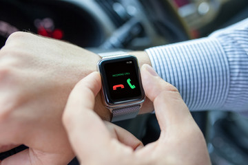 man with smart watch and incoming call in thr car