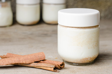 Cinnamon yogurt, rustic background.