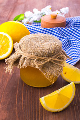 Honey comb, fresh lemon and a sprig of blossoms on a wooden table