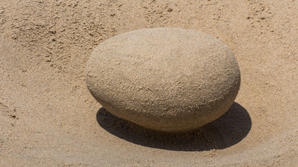 Fototapeta na wymiar sand-made egg on the beach